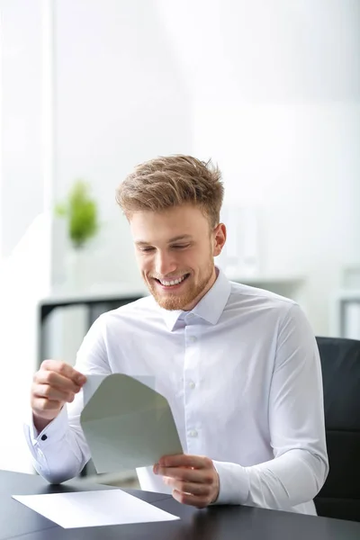 Young man receiving invitation in office — Stock Photo, Image