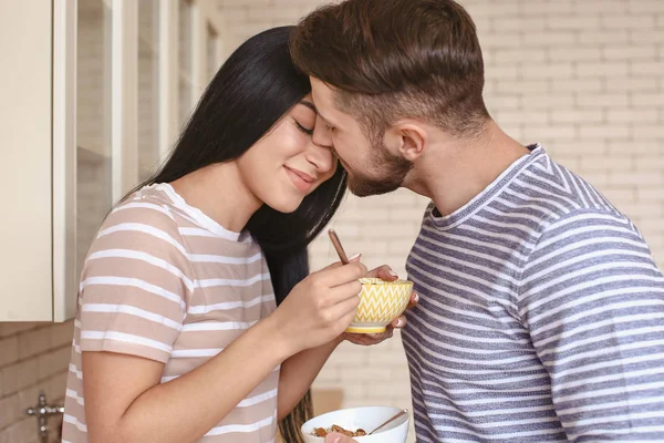 Cute young couple having breakfast in kitchen — Stock Photo, Image