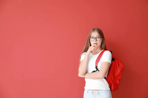 Shocked teenage girl on color background — Stock Photo, Image