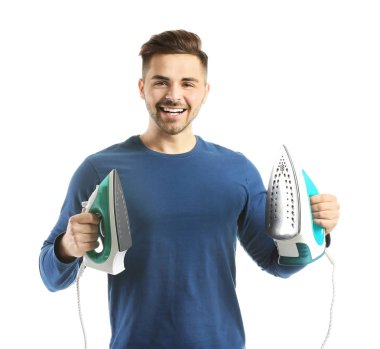 Young man with irons on white background