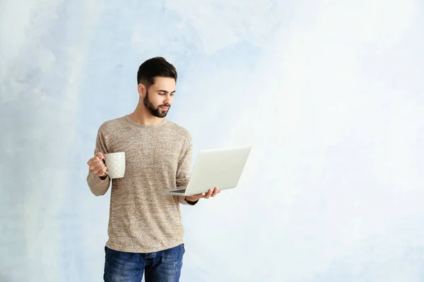 컬러 배경에 노트북과 커피 한 잔을 가진 남성 프로그래머 — 스톡 사진