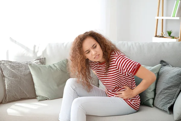 African-American woman suffering from abdominal pain at home — Stock Photo, Image