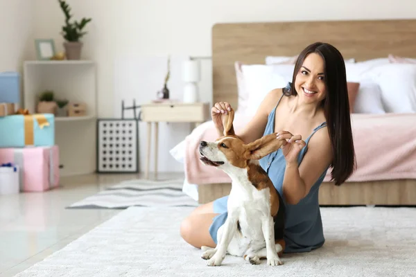 Jovem mulher com cão bonito em casa — Fotografia de Stock