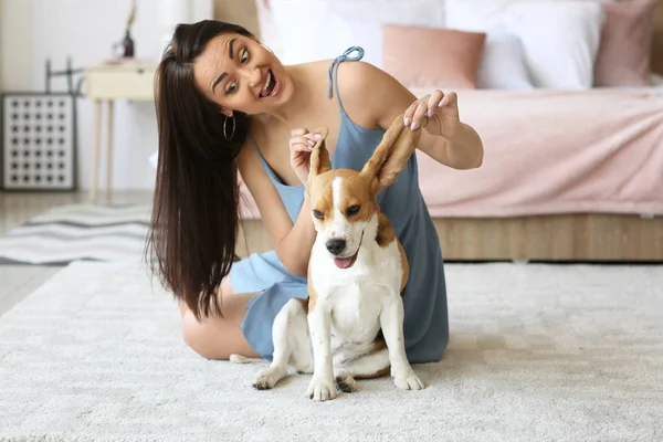 Jovem mulher com cão bonito em casa — Fotografia de Stock