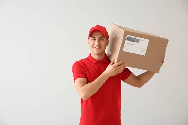 Delivery man with box on white background