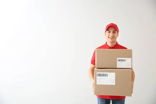 Delivery man with boxes on white background