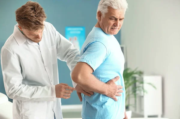 Urologist examining male patient in clinic Royalty Free Stock Images