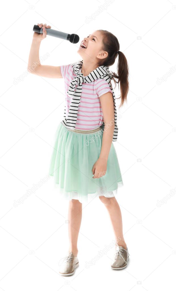 Little girl with microphone singing against white background