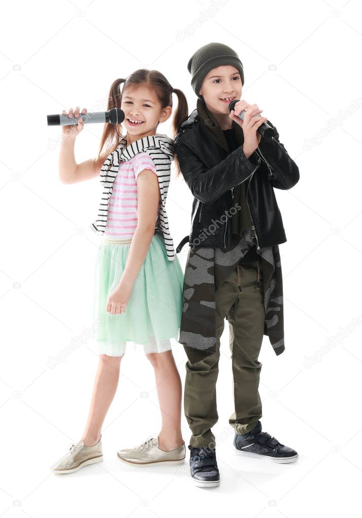 Cute little singers with microphones on white background