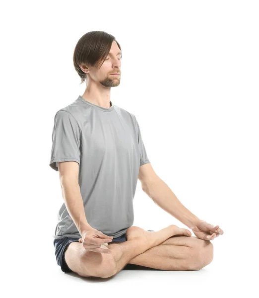 Sportieve man beoefenen van yoga op witte achtergrond — Stockfoto