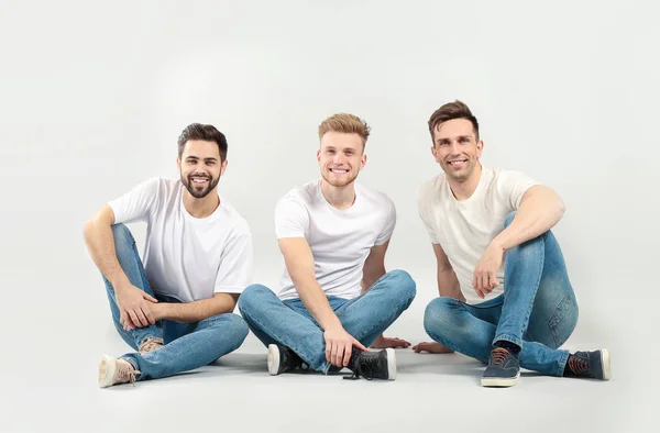 Handsome young men on light background