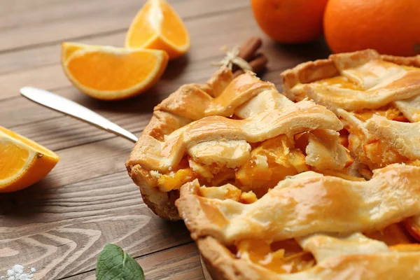Tasty orange pie on wooden table, closeup — Stock Photo, Image