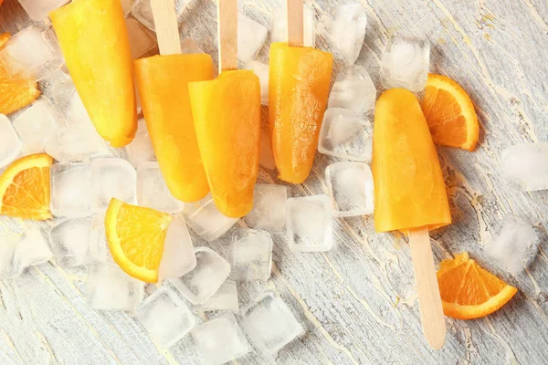 Tasty orange ice cream on white table — Stock Photo, Image