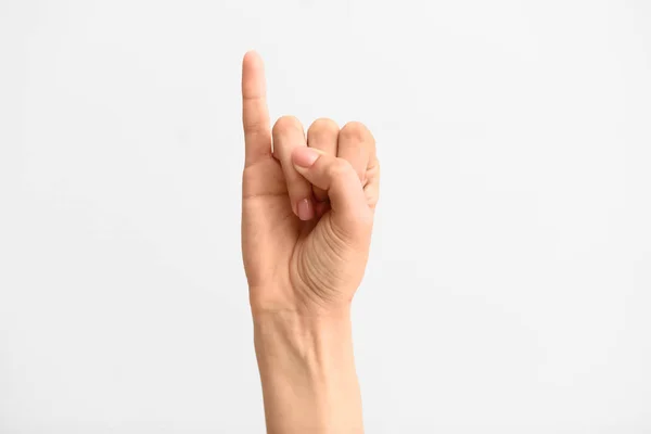 I. betűt ábrázoló, világos hátterű női kéz — Stock Fotó