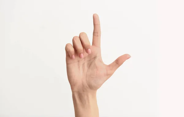Kobiece ręka pokazując literę L na jasnym tle — Zdjęcie stockowe