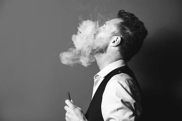 Black and white portrait of young man smoking hookah — Stock Photo, Image