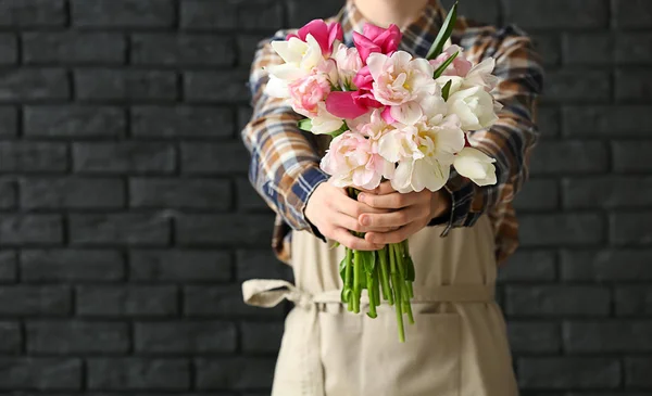 Handsome florist on dark background — Stock Photo, Image