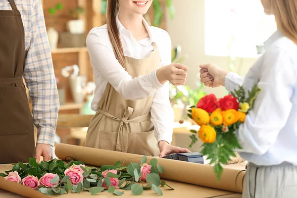 Woman buying bouquet in flower shop