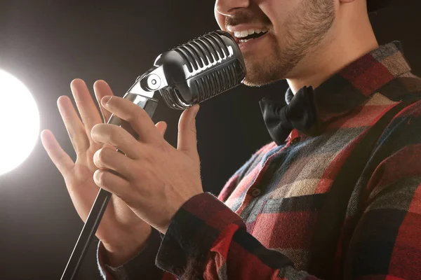 Handsome male singer with microphone on stage, closeup — Stock Photo, Image