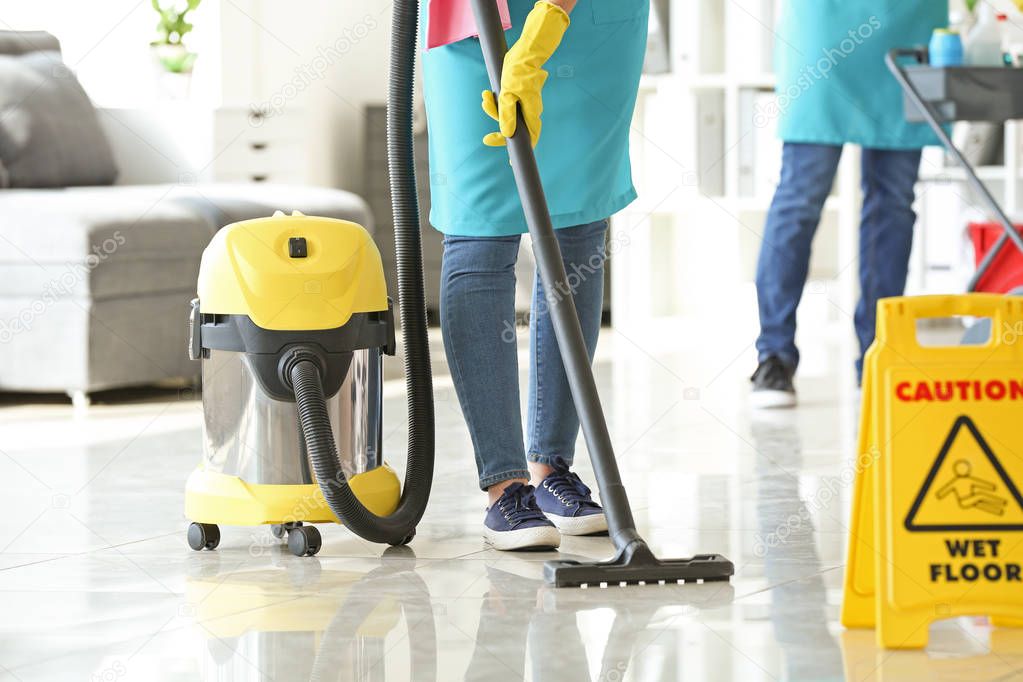 Team of janitors cleaning office