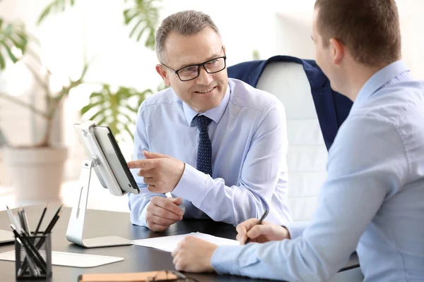 Handsome mature businessman with colleague working in office — Stock Photo, Image
