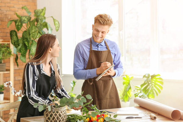 Young florists working in shop