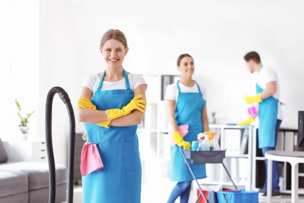Female janitor and her team in office — Stock Photo, Image
