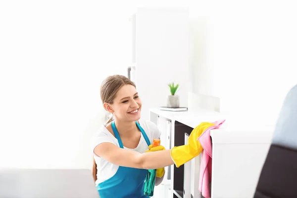 Female janitor cleaning office
