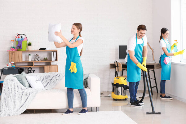 Team of janitors cleaning flat