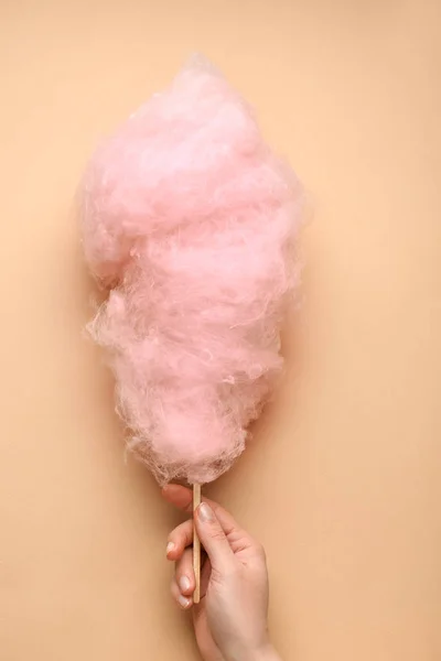 Female hand with tasty cotton candy on color background — Stock Photo, Image