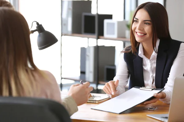 Real estate agent working with clients in office — Stock Photo, Image