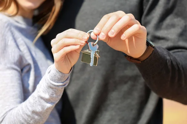 Young couple with key from their new house, closeup — Stock Photo, Image