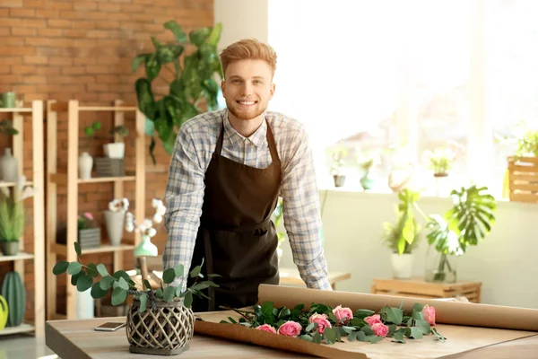 Young male florist at workplace in shop — Stock Photo, Image