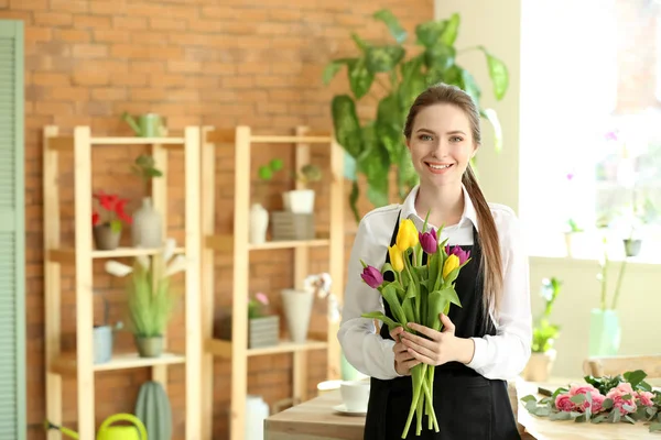 Young florist with bouquet in flower shop — Stock Photo, Image