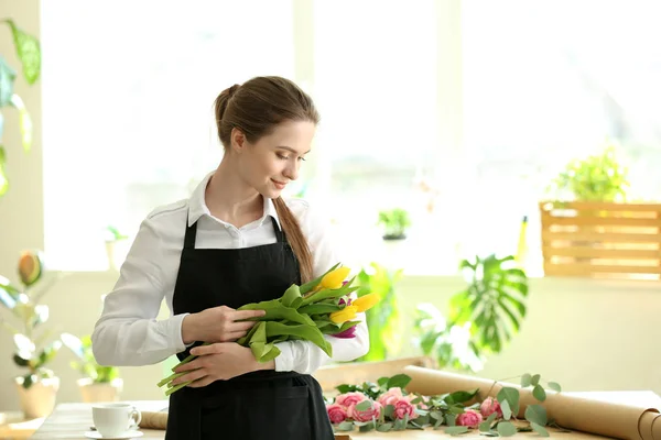 Young florist with bouquet in flower shop — Stock Photo, Image