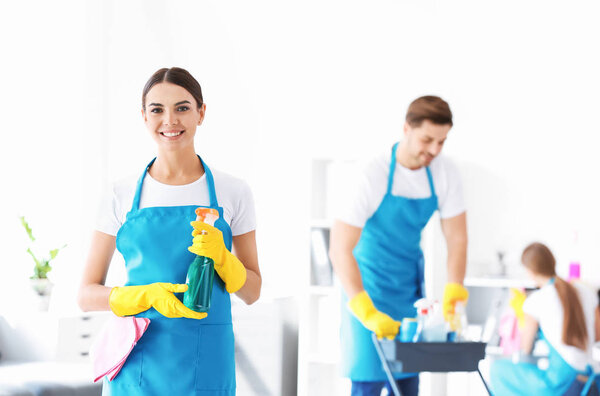 Female janitor and her team in office