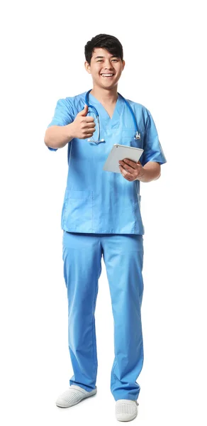 Retrato de assistente médico masculino com computador tablet mostrando polegar para cima no fundo branco — Fotografia de Stock