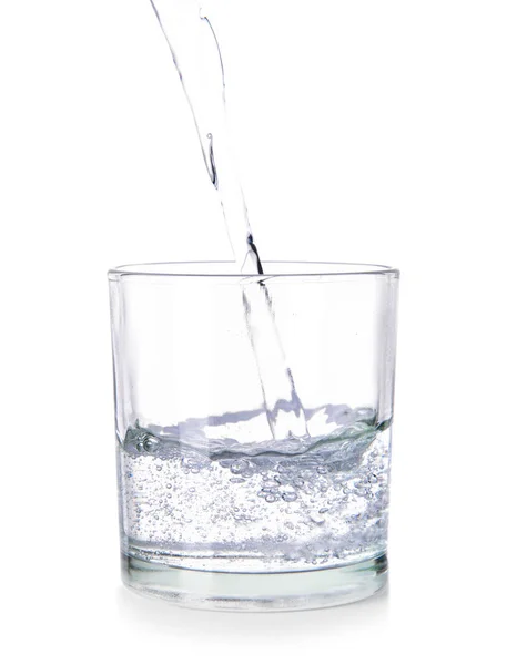 Pouring of fresh water into glass on white background — Stock Photo, Image