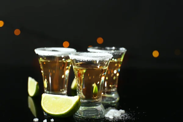 Shots of tequila on dark background — Stock Photo, Image