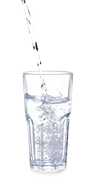 Pouring of fresh water into glass on white background Stock Image