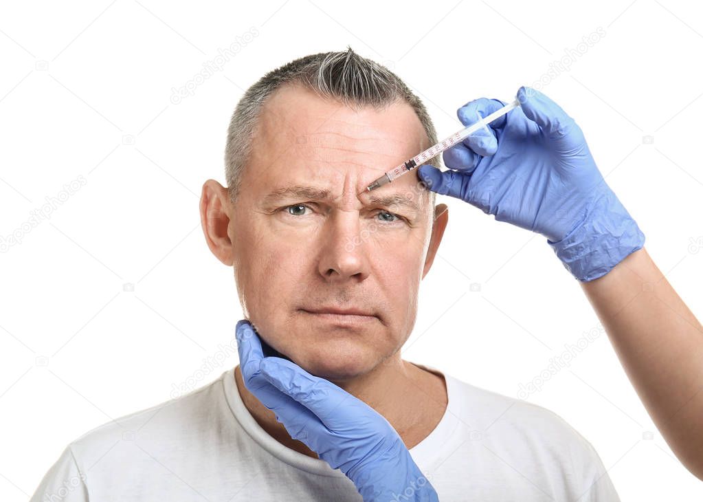 Middle-aged man and hands holding syringe for anti-aging injections on white background