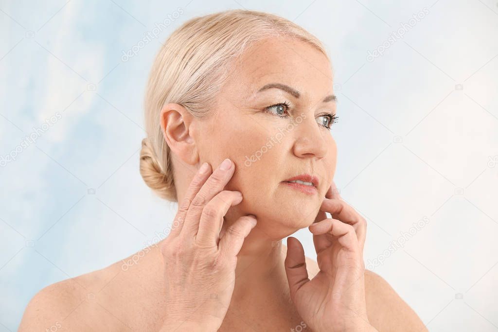 Mature woman on light background