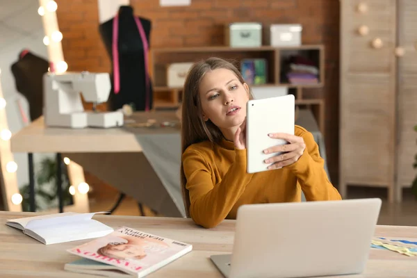 Beautiful female business owner working in atelier — Stock Photo, Image