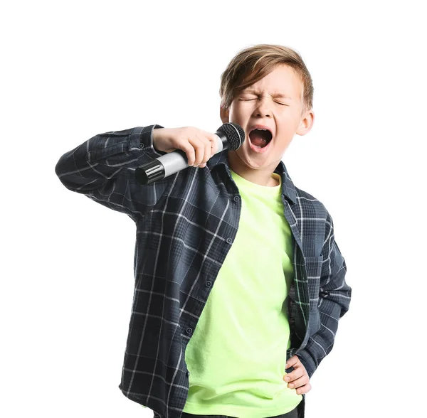 Netter kleiner Junge mit Mikrofon singt vor weißem Hintergrund — Stockfoto