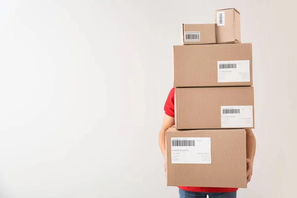 Delivery man with boxes on white background