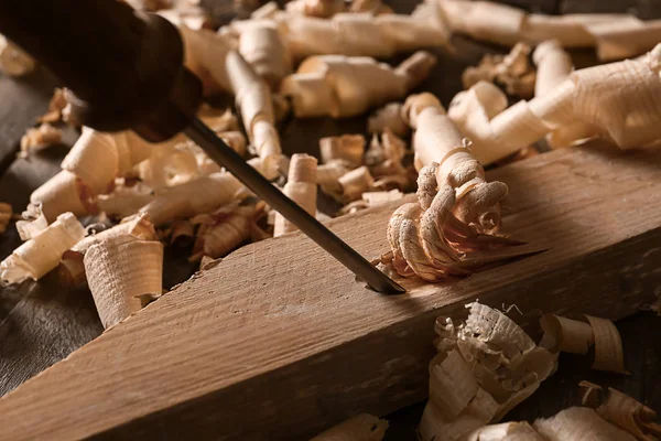 Chiseling wooden part in carpenter's workshop, closeup — Stock Photo, Image
