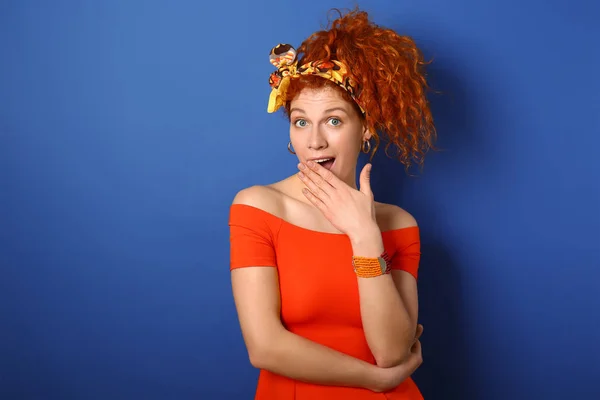 Surprised redhead woman on color background — Stock Photo, Image