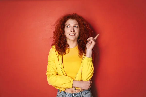 Thoughtful redhead woman on color background — Stock Photo, Image