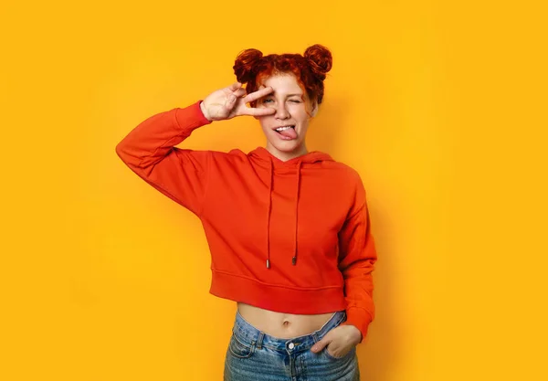 Beautiful redhead woman showing victory gesture on color background — 스톡 사진