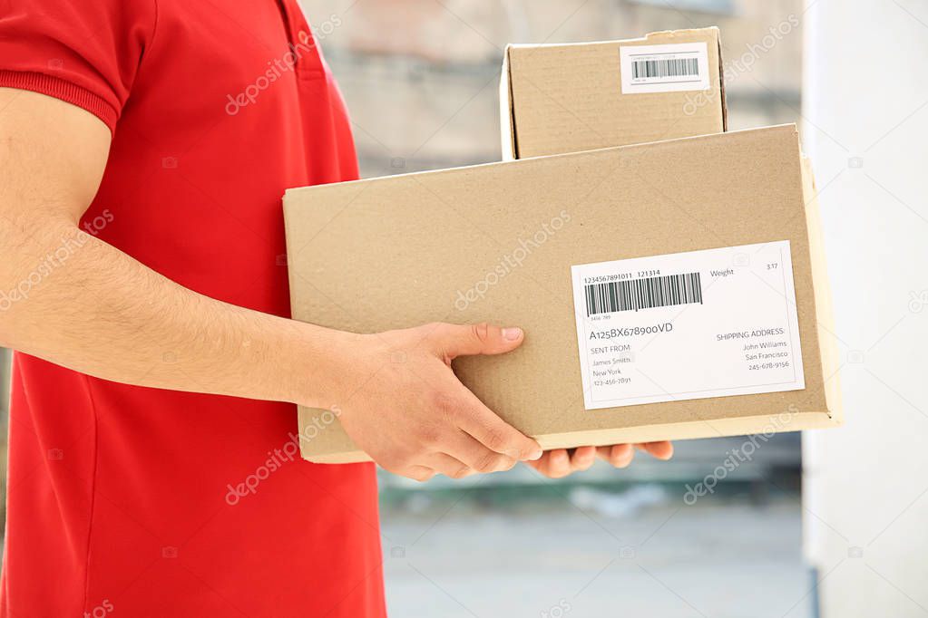 Delivery man with boxes outdoors